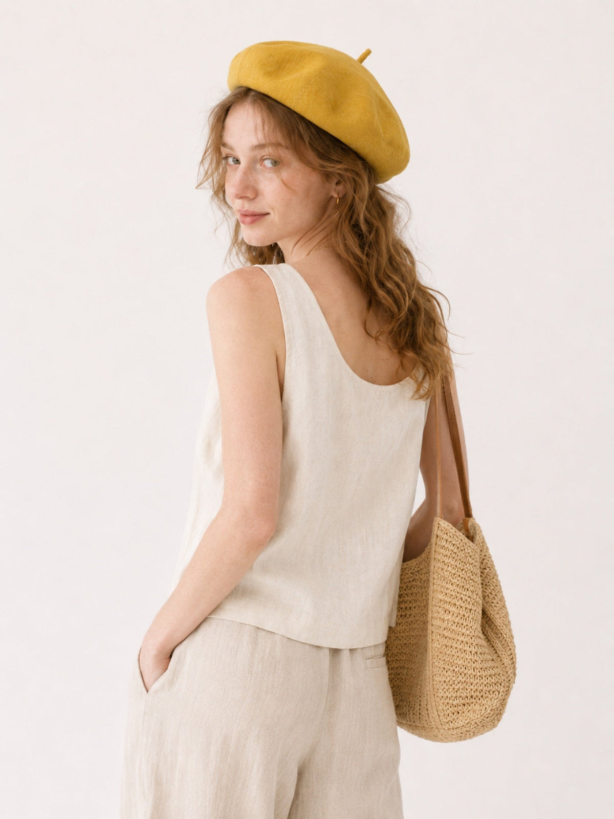 Woman wearing oversized linen French beret – Mustard