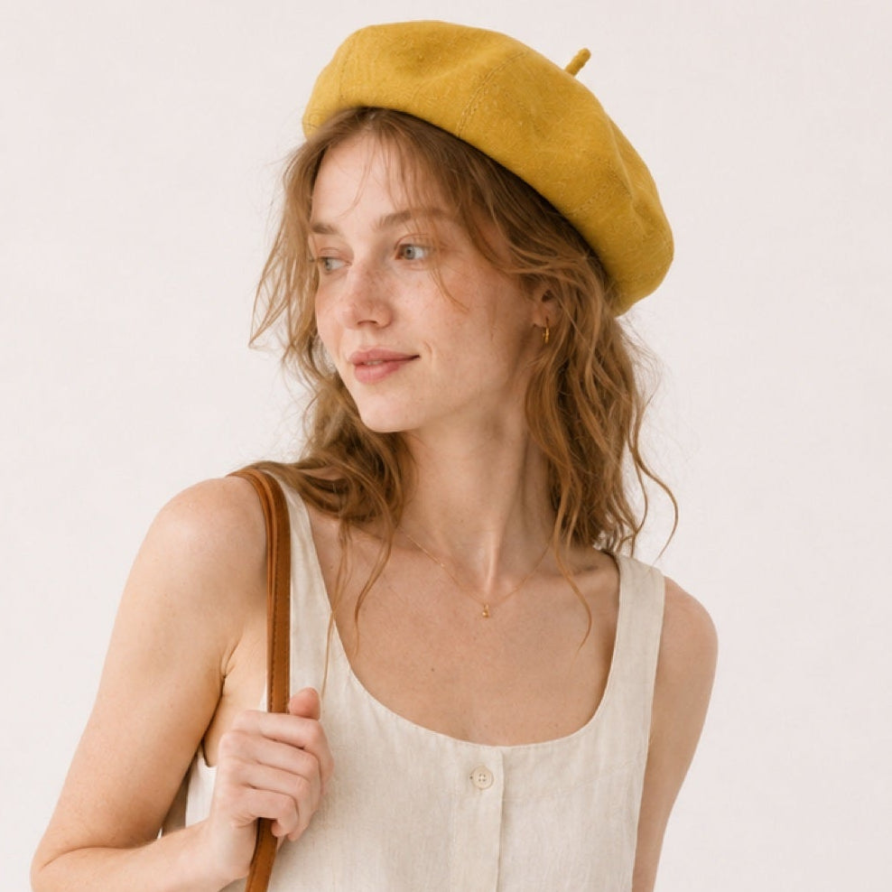 Woman wearing mustard linen beret