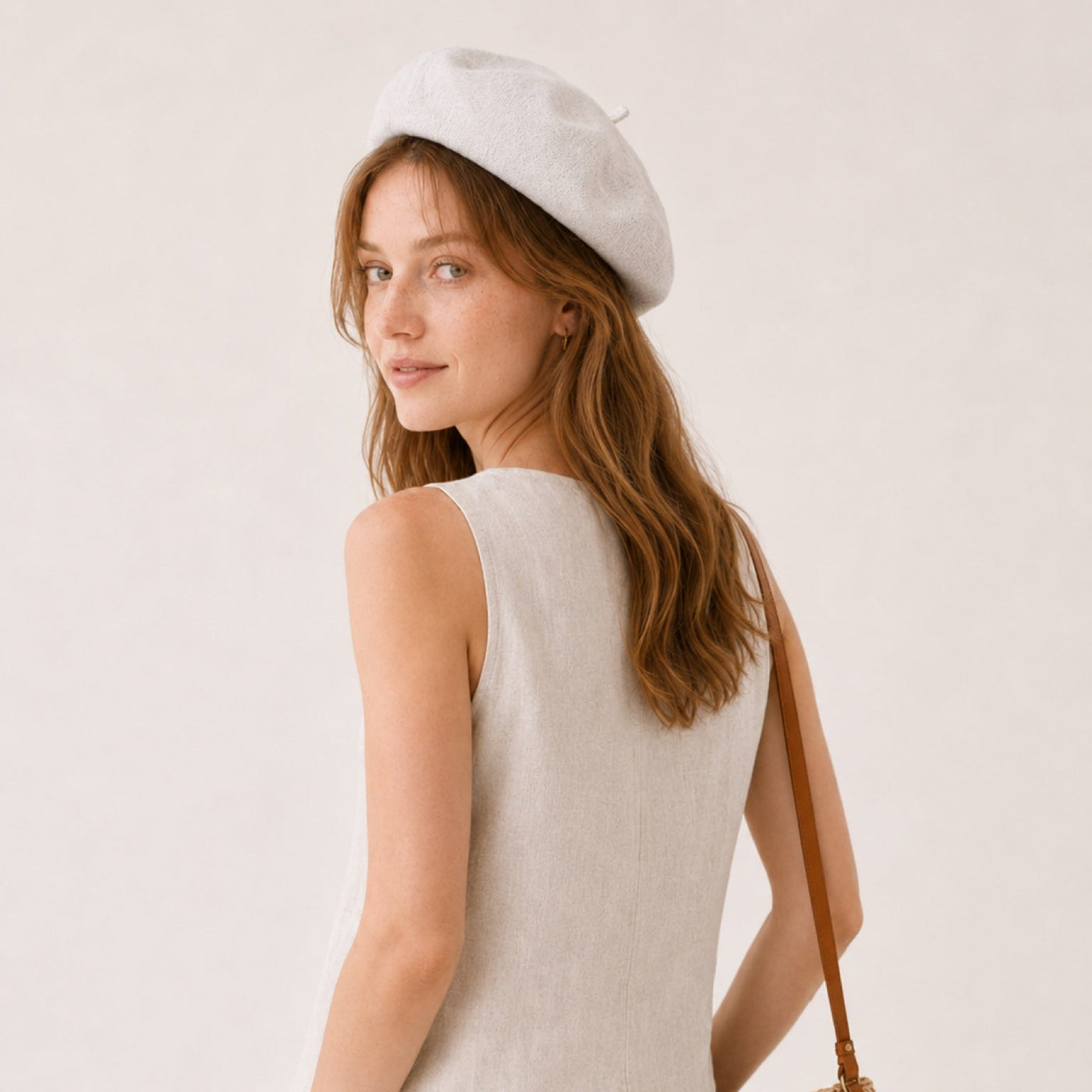 Woman wearing off-white linen beret