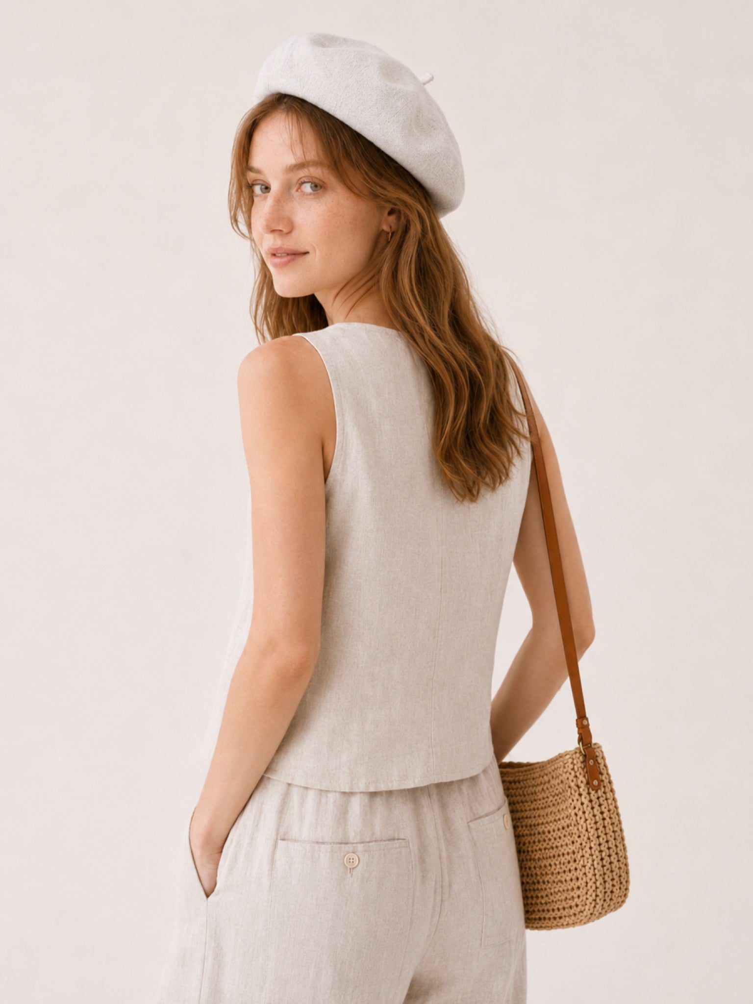 Woman wearing off-white linen beret
