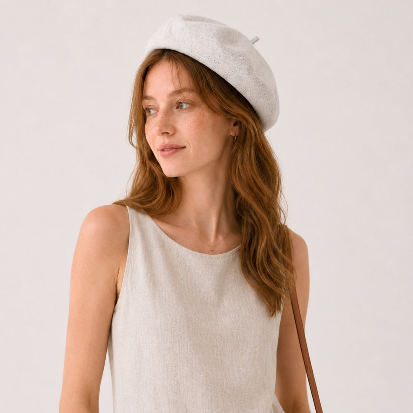 Woman wearing off-white linen beret