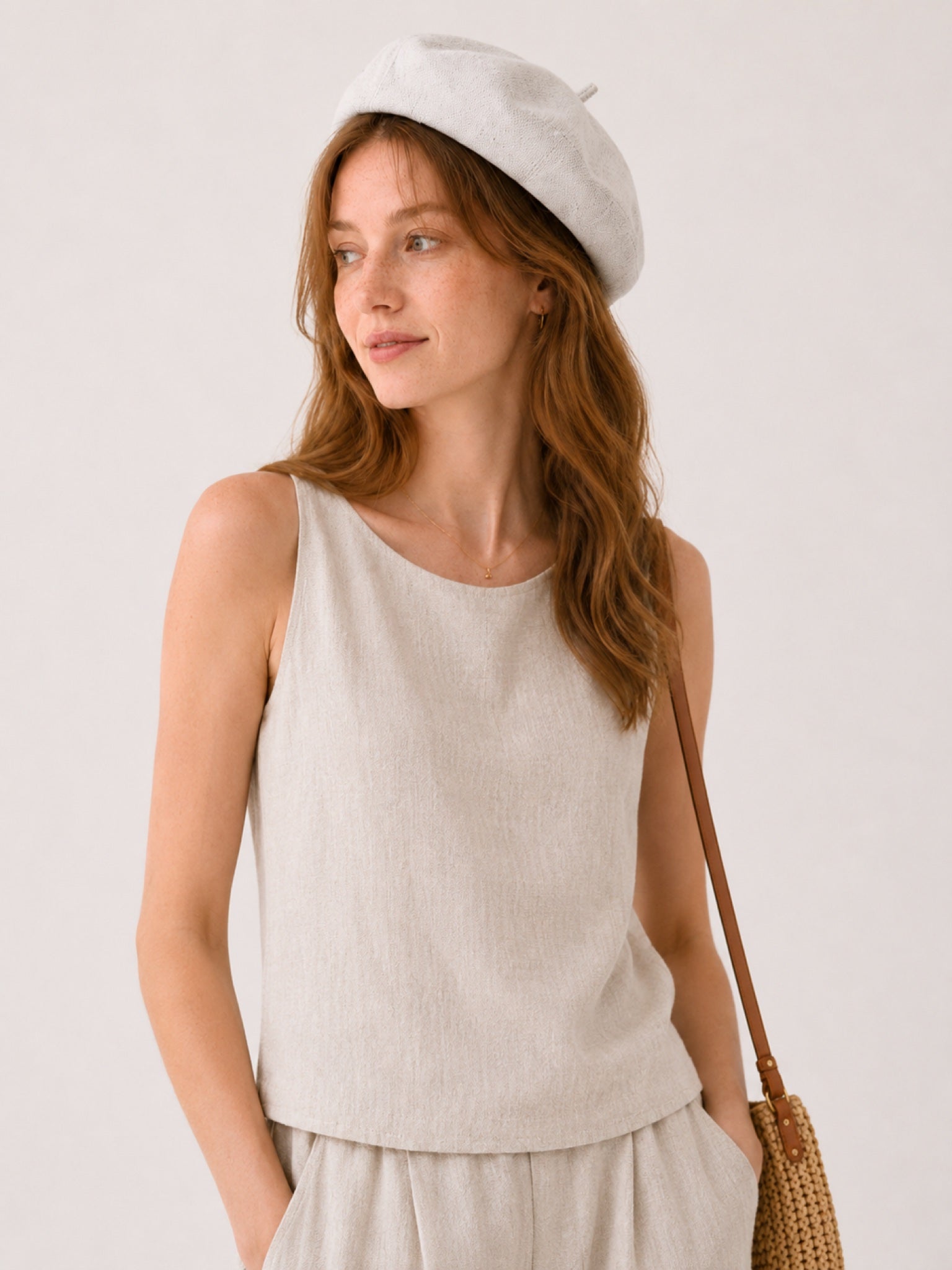 Woman wearing off-white linen beret