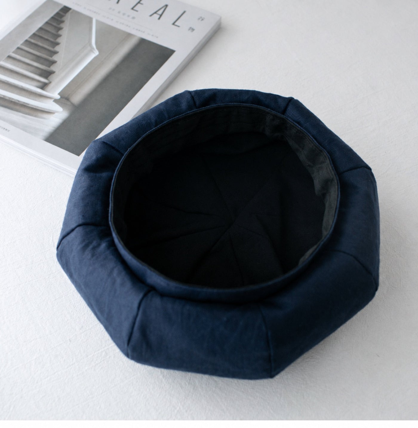Navy linen beret interior detail showing soft black lining and eight-panel construction