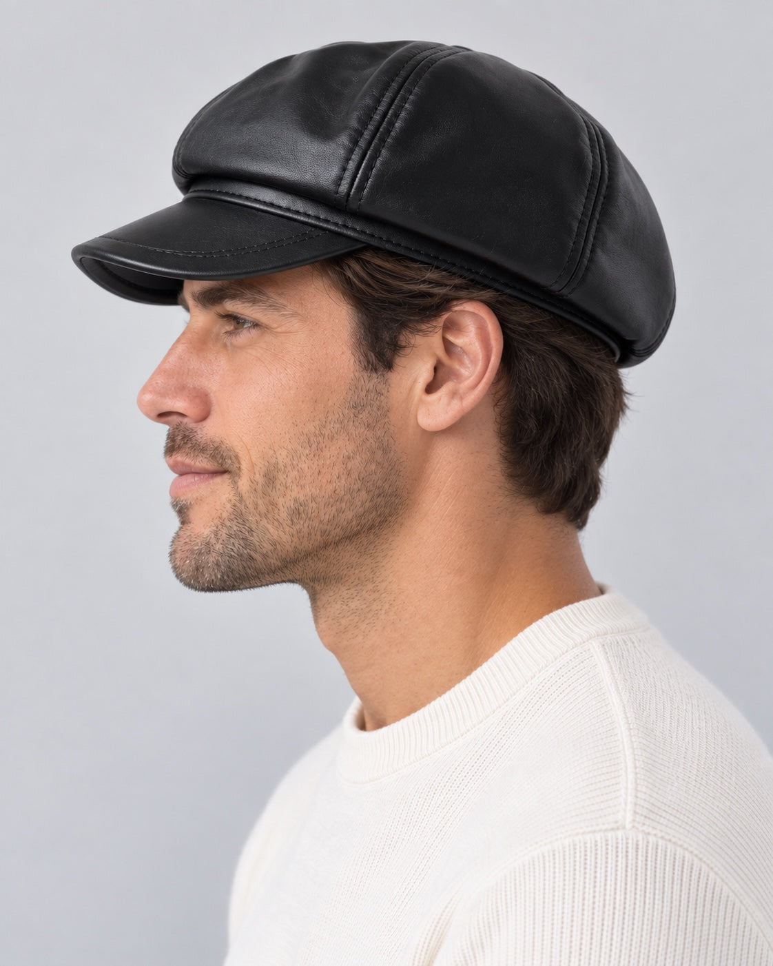 Man wearing the black genuine leather short-brim newsboy cap, side profile