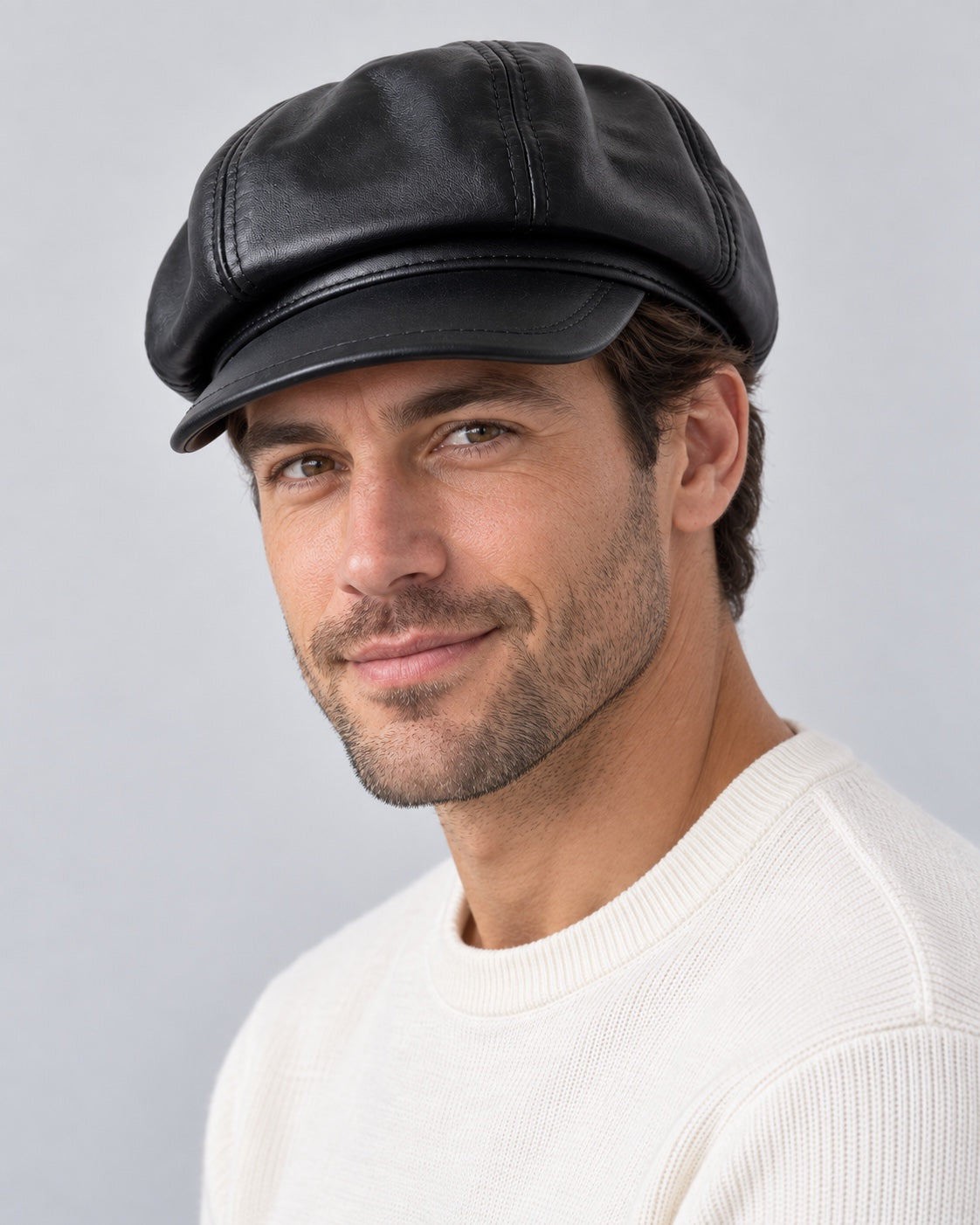 Man wearing the black genuine leather short-brim newsboy cap, three-quarter view