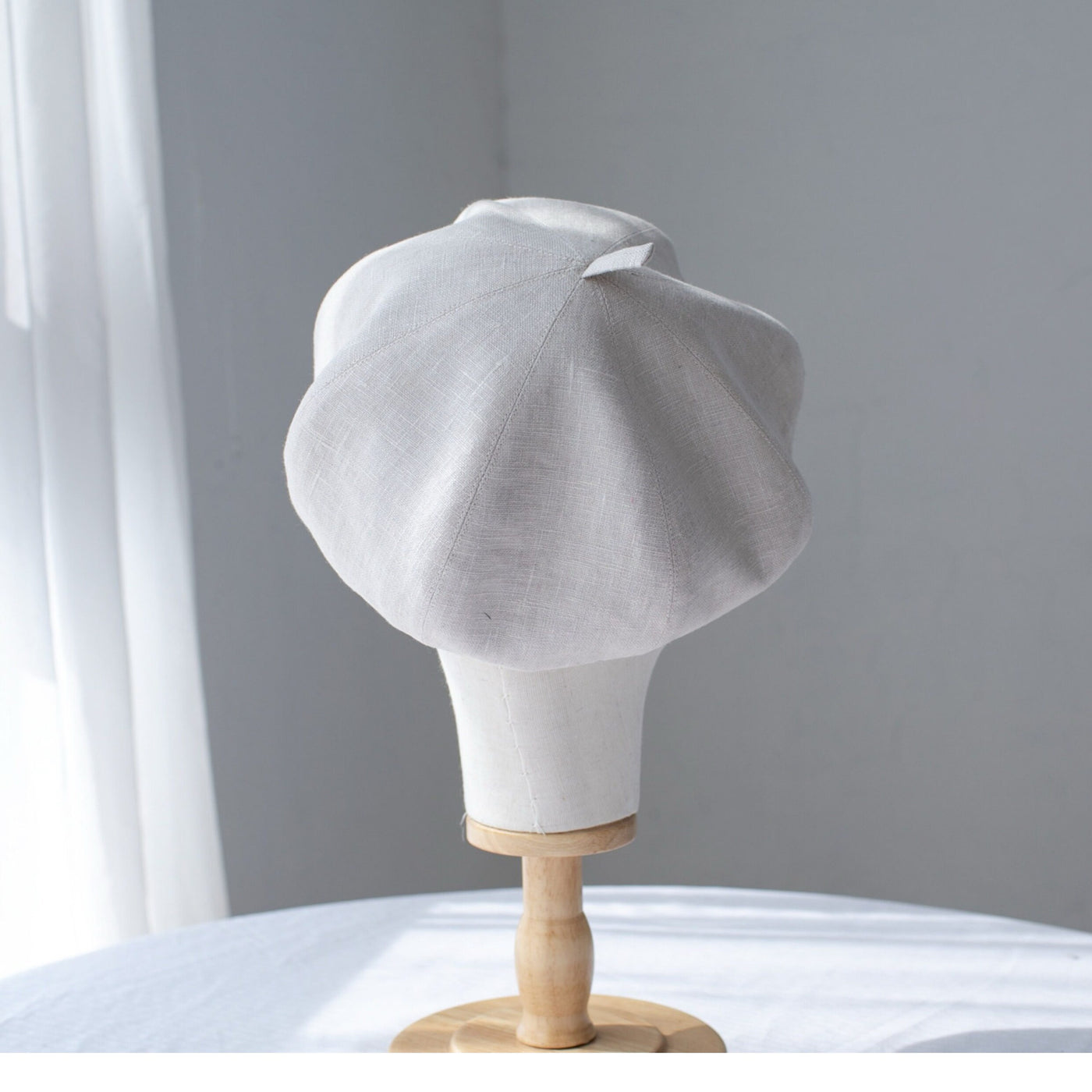 Off-white linen beret detail