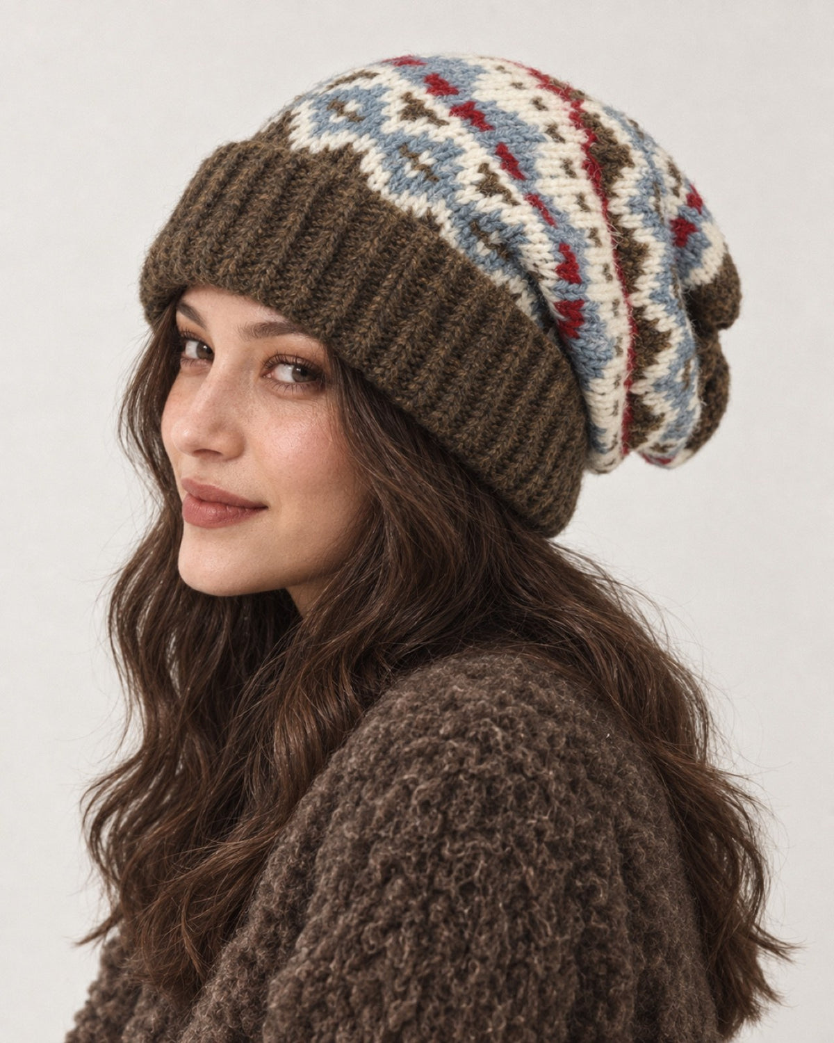 Young woman wearing the Olive Brown Fair Isle oversized slouchy beanie, side studio portrait