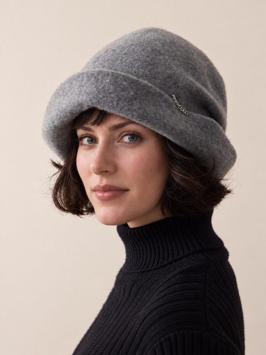 White female model wearing the Smoke Grey wool slouchy cloche hat in a front studio view