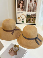 Straw cloche hats in brown and grey ribbon styles lifestyle photo
