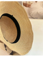 Interior sweatband detail of straw cloche hat