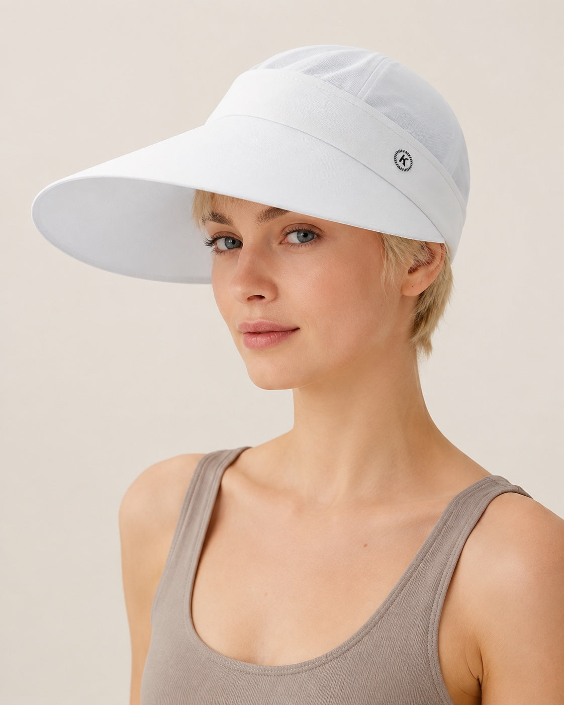 White 2-in-1 wide brim sun hat with removable top for women, shown on a studio model