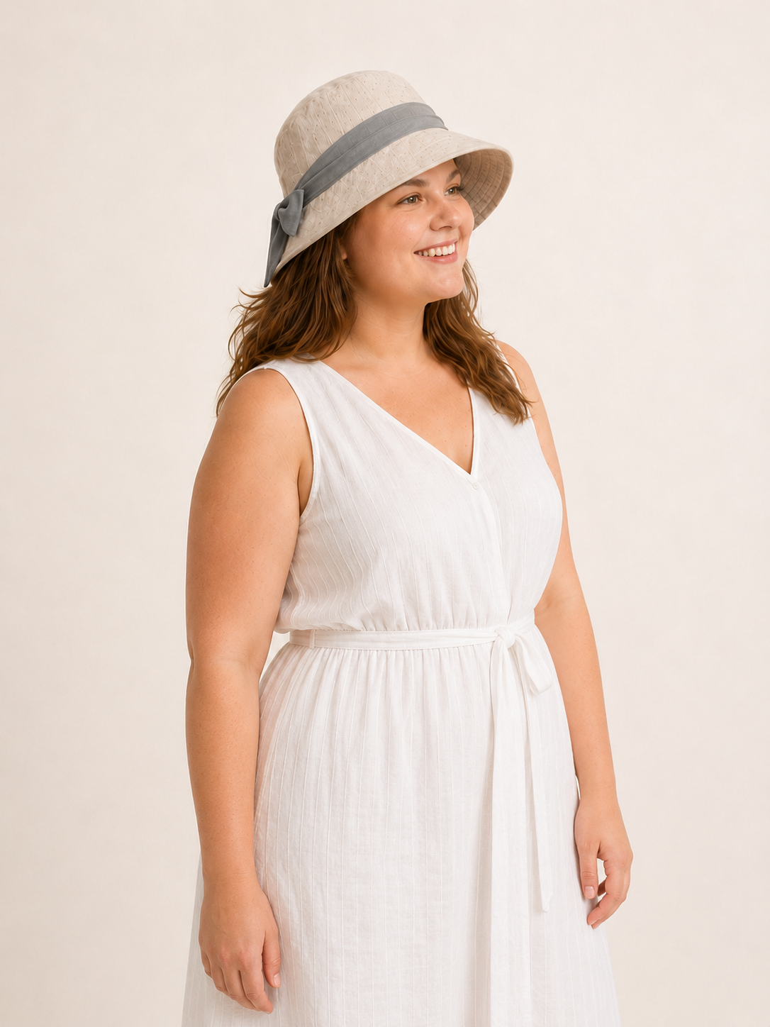 Woman wearing cotton linen wide-brim bow bucket hat, UPF 50+ sun hat for women