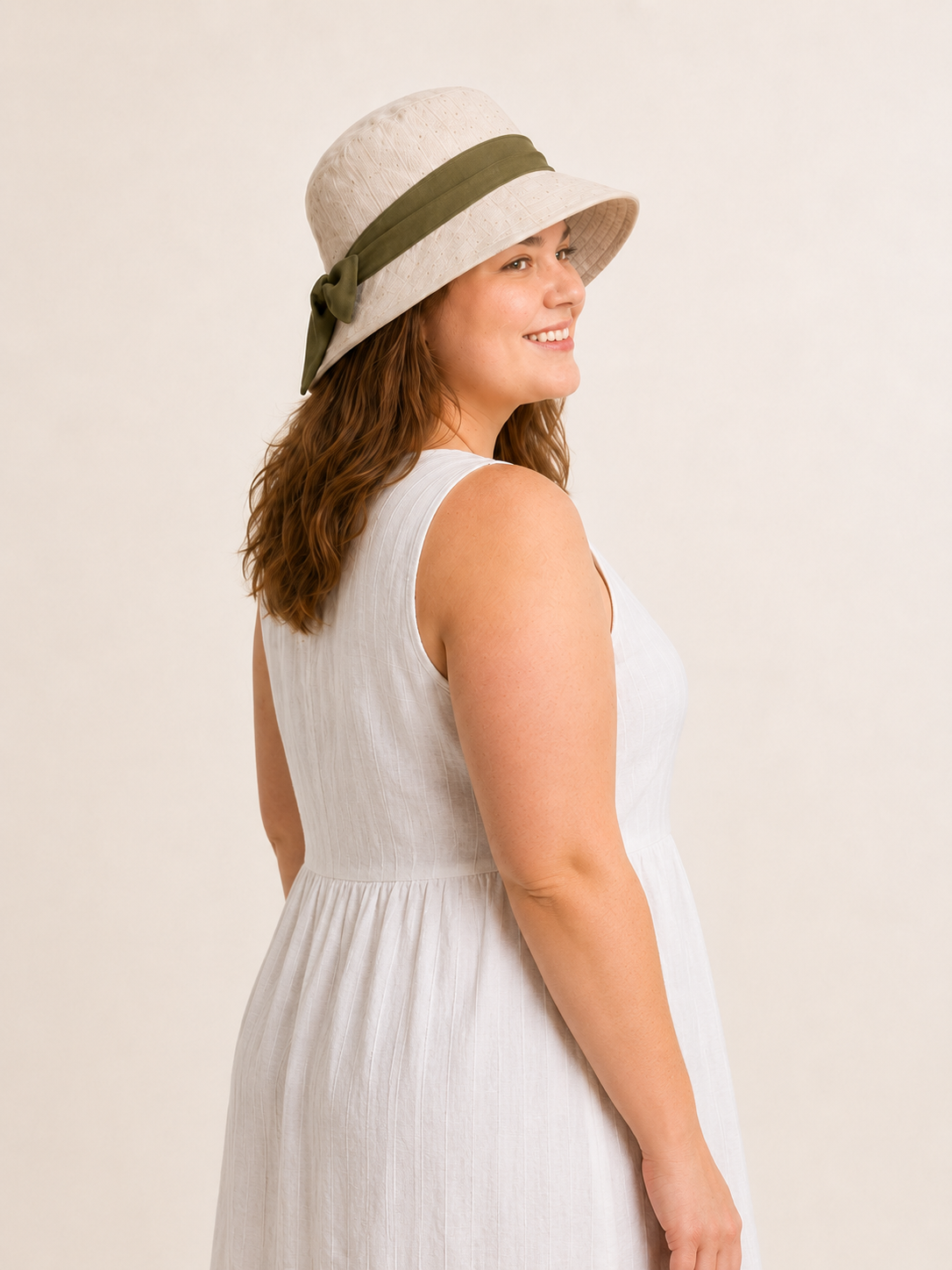 Woman wearing cotton linen wide-brim bow bucket hat, UPF 50+ sun hat for women