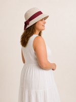 Woman wearing cotton linen wide-brim bow bucket hat, UPF 50+ sun hat for women