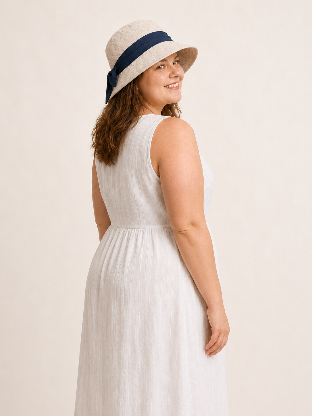 Woman wearing cotton linen wide-brim bow bucket hat, UPF 50+ sun hat for women