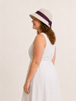 Woman wearing cotton linen wide-brim bow bucket hat, UPF 50+ sun hat for women