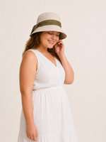 Woman wearing cotton linen wide-brim bow bucket hat, UPF 50+ sun hat for women
