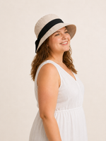 Woman wearing cotton linen wide-brim bow bucket hat, UPF 50+ sun hat for women