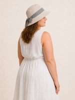 Woman wearing cotton linen wide-brim bow bucket hat, UPF 50+ sun hat for women