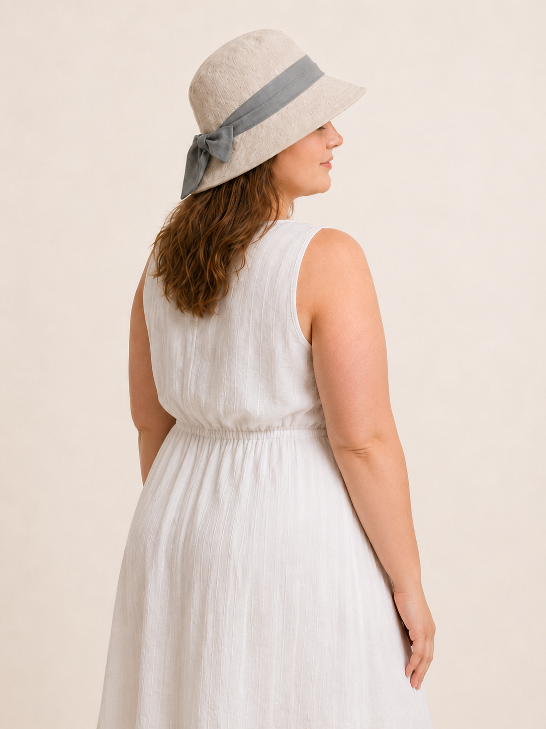 Woman wearing cotton linen wide-brim bow bucket hat, UPF 50+ sun hat for women