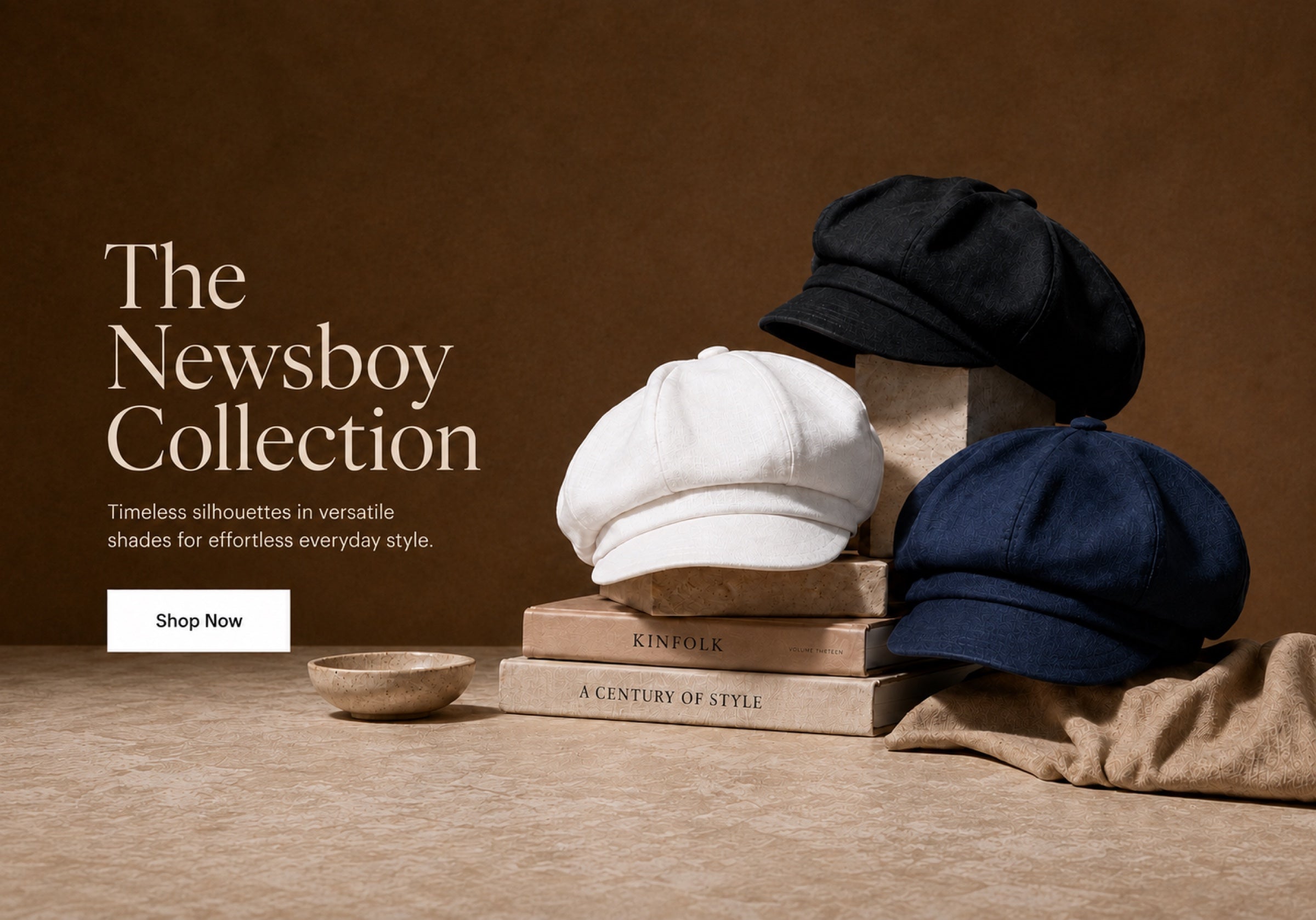 Black, white, and navy newsboy caps displayed on warm neutral blocks