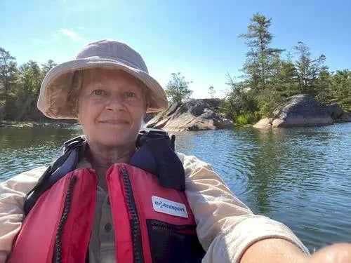 Malvina wearing a wide-brim bucket hat outdoors